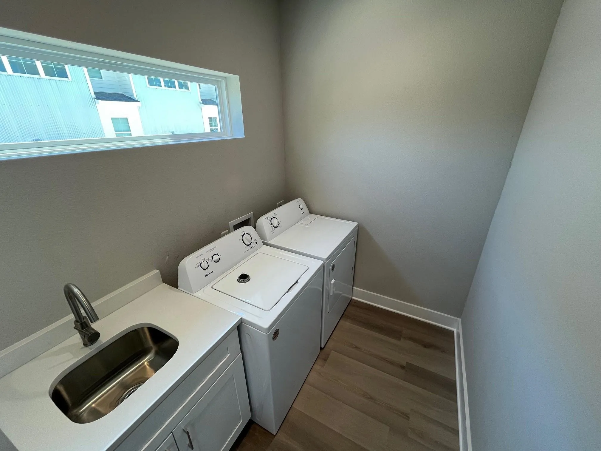 Utility room in the 4 bedroom unity with a separate sink and great window