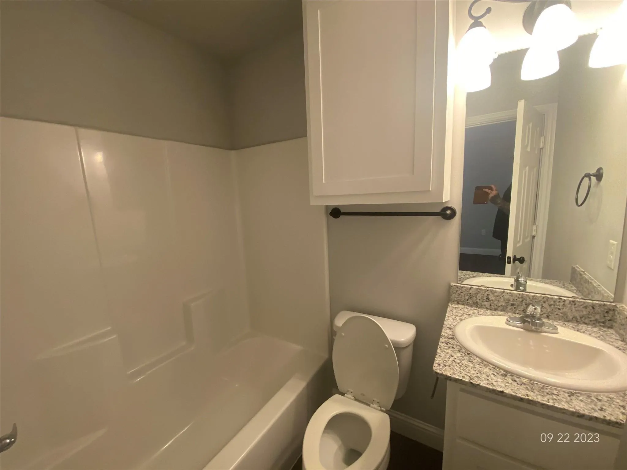 Upstairs bathroom with tub/shower combination, under sink cabinet and linen/medicine cabinet above toilet.