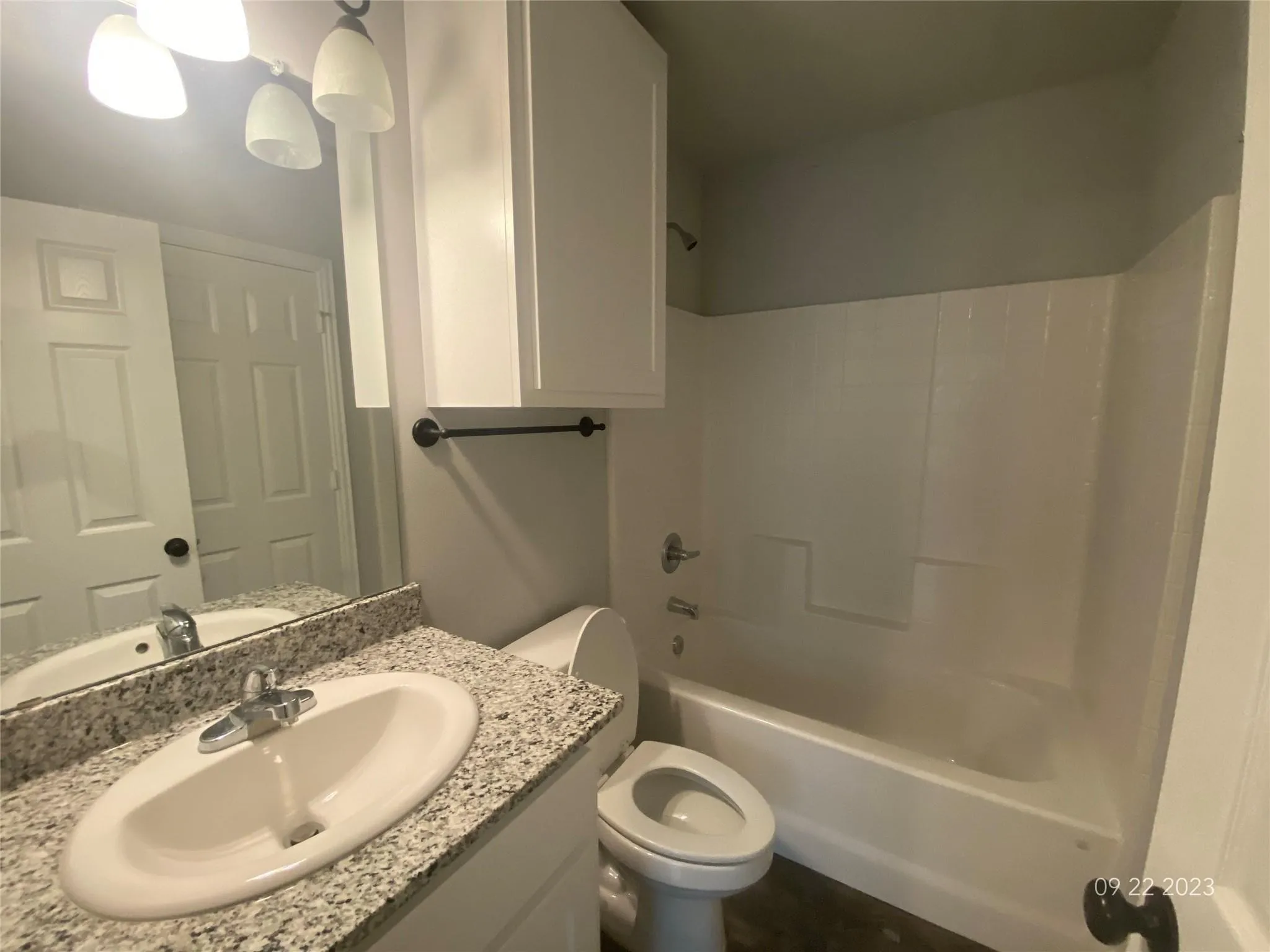 Downstairs bathroom with tub/shower combination, under sink cabinet and linen/medicine cabinet above toilet.
