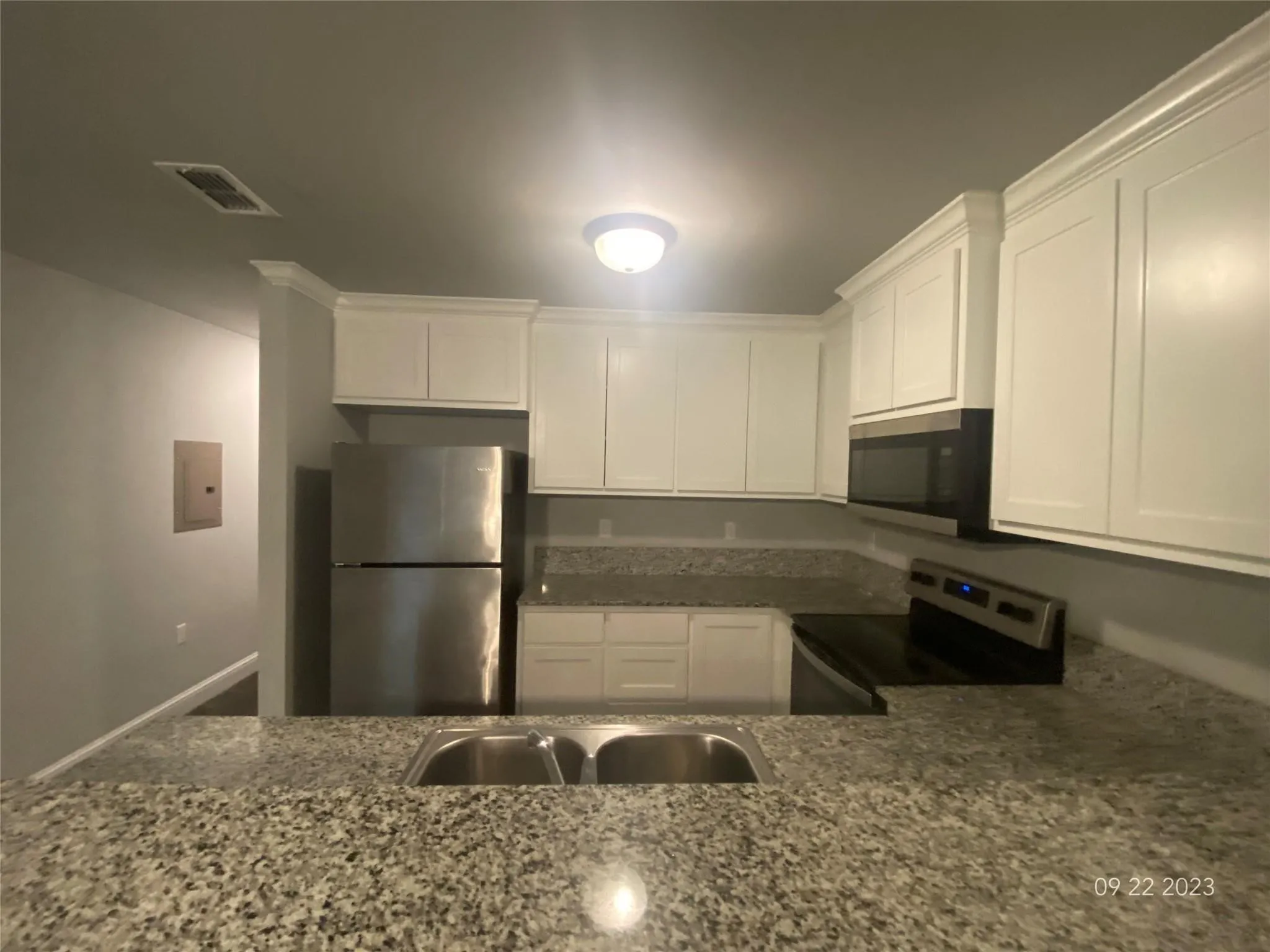 Kitchen has dual sink, refrigerator, stove, and dishwasher