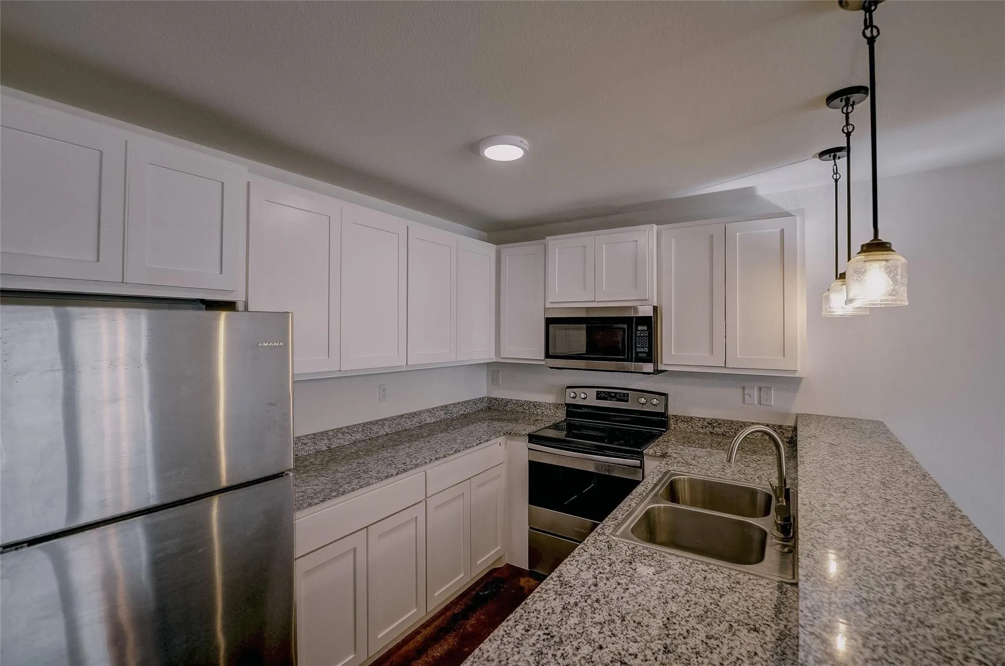 Kitchen has dishwasher, microwave, stove and refrigerator