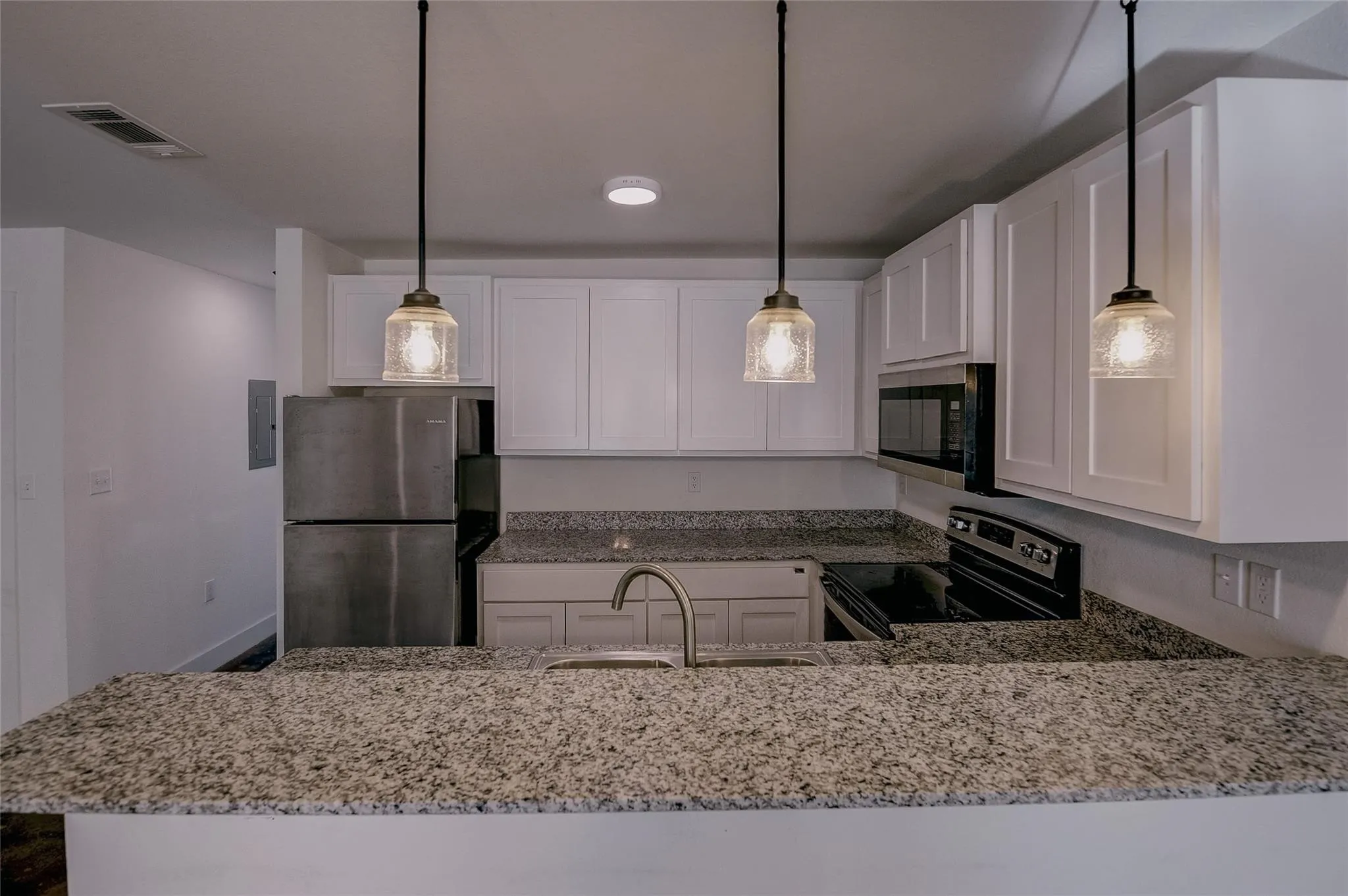 Kitchen has dishwasher, microwave, stove and refrigerator