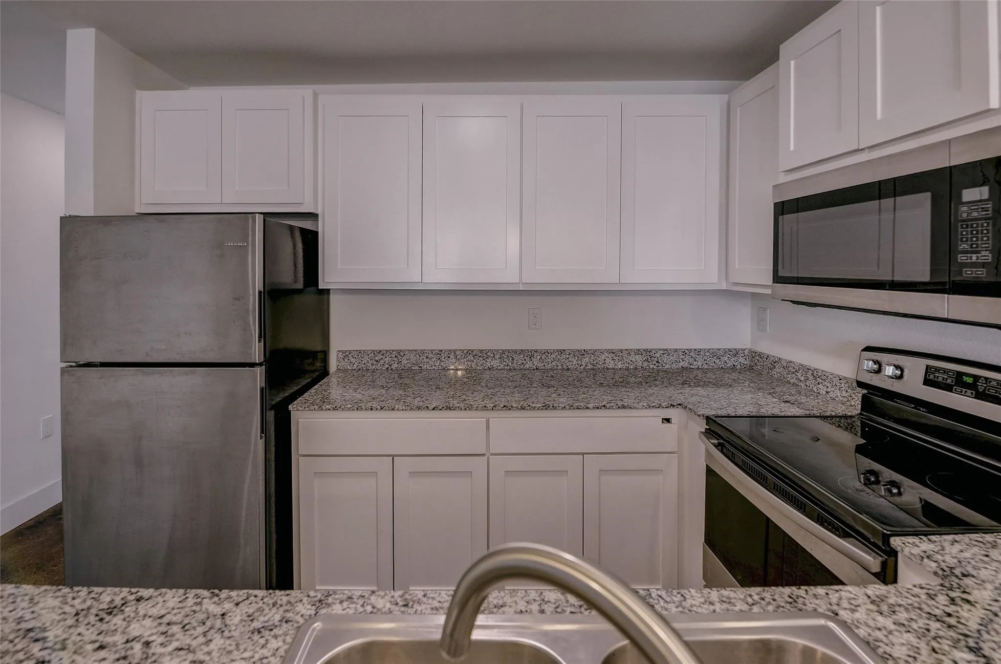 Kitchen has dishwasher, microwave, stove and refrigerator