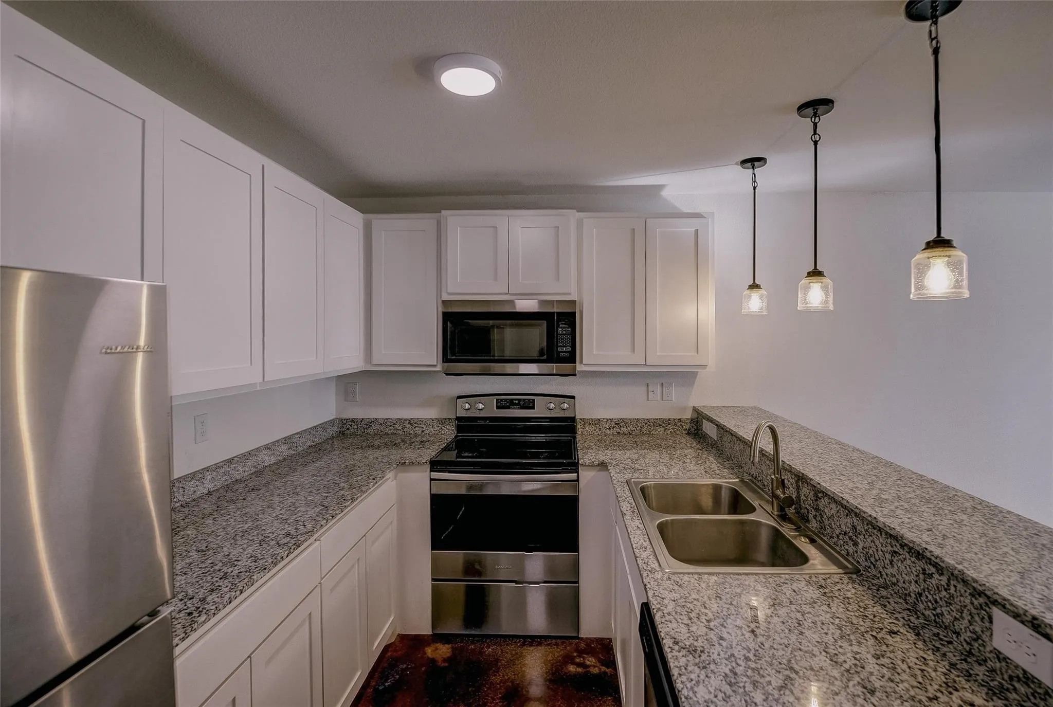 Kitchen has dishwasher, microwave, stove and refrigerator