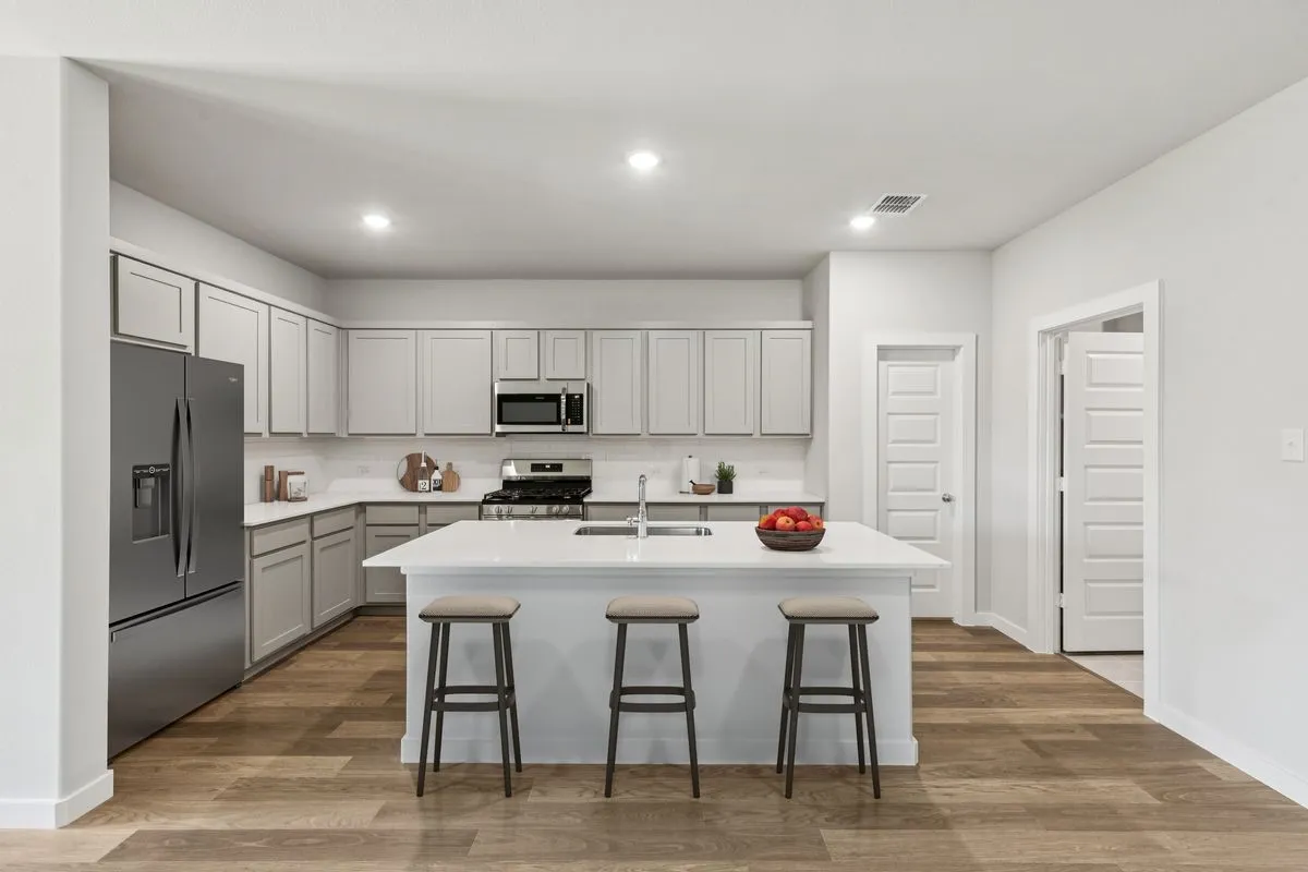 Kitchen in the Oscar home plan by Trophy Signature Homes – REPRESENTATIVE PHOTO