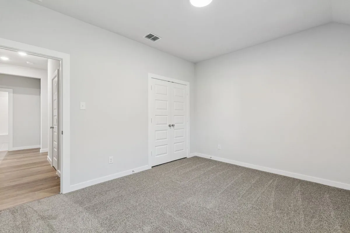 Bedroom in the Oscar home plan by Trophy Signature Homes – REPRESENTATIVE PHOTO