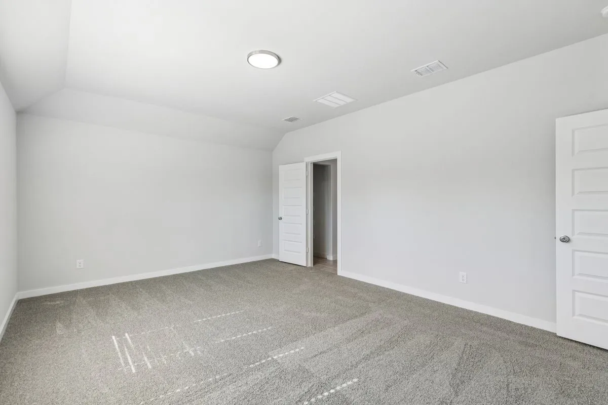 Primary Suite in the Oscar home plan by Trophy Signature Homes – REPRESENTATIVE PHOTO