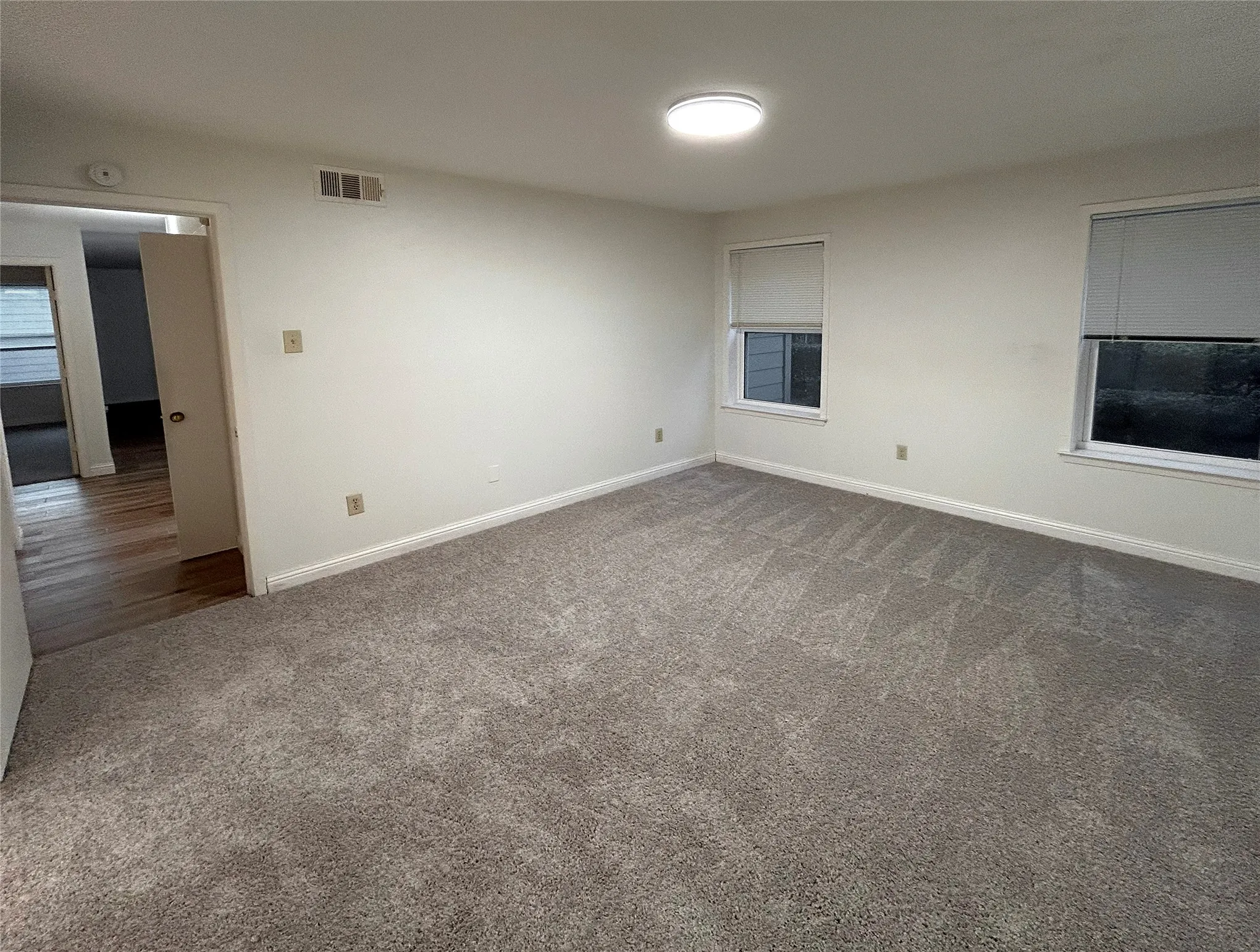 The primary bedroom has an ensuite bathroom and a walk-in closet. It is located at the end of the hallway near the laundry room. New carpet was installed in 2026. The primary bedroom has an ensuite bathroom and a walk-in closet. It is located at the end of the hallway near the laundry room. New carpet was installed in 2026.