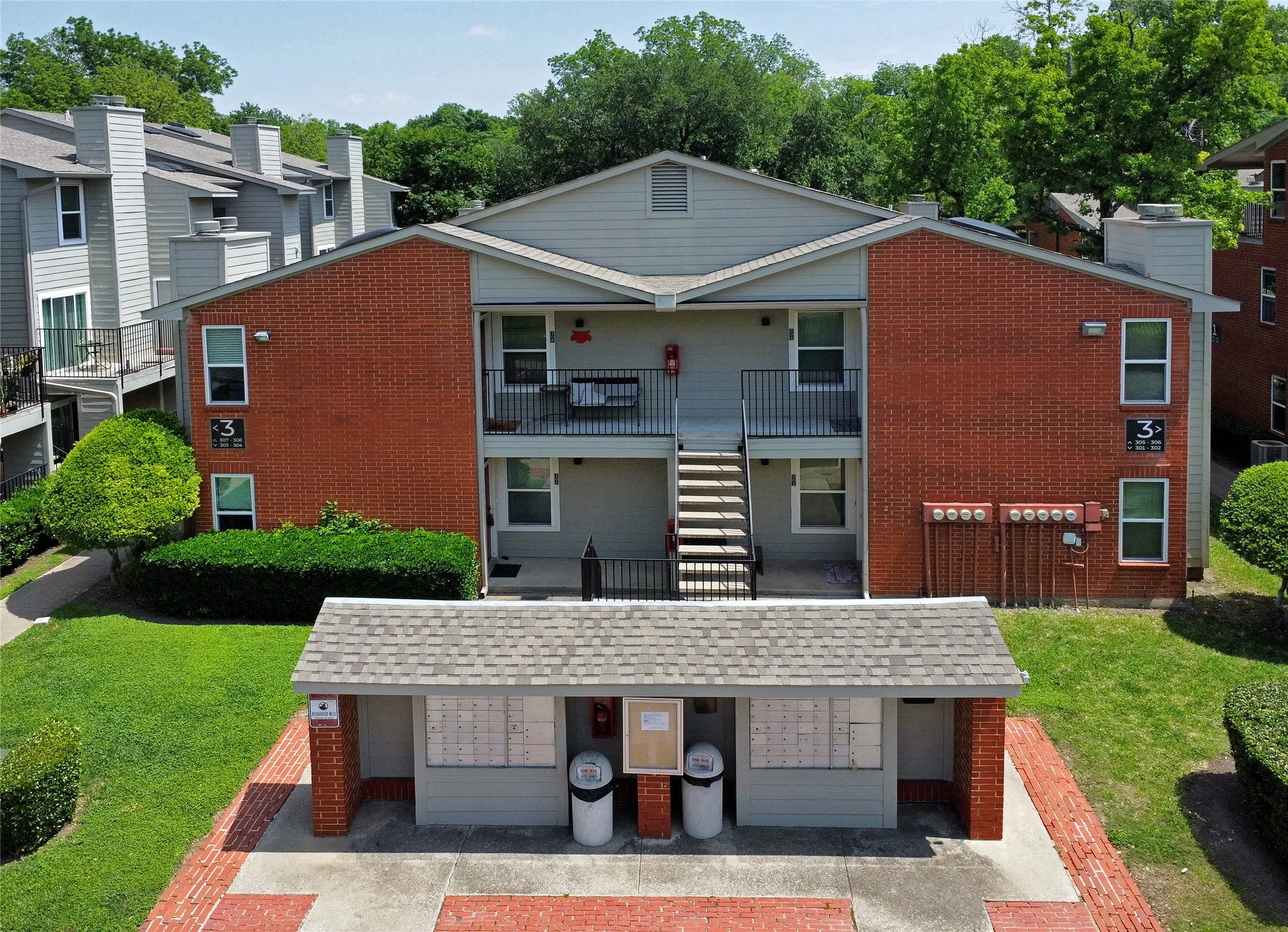 Drone photo of exterior front view of property and community mailboxes.