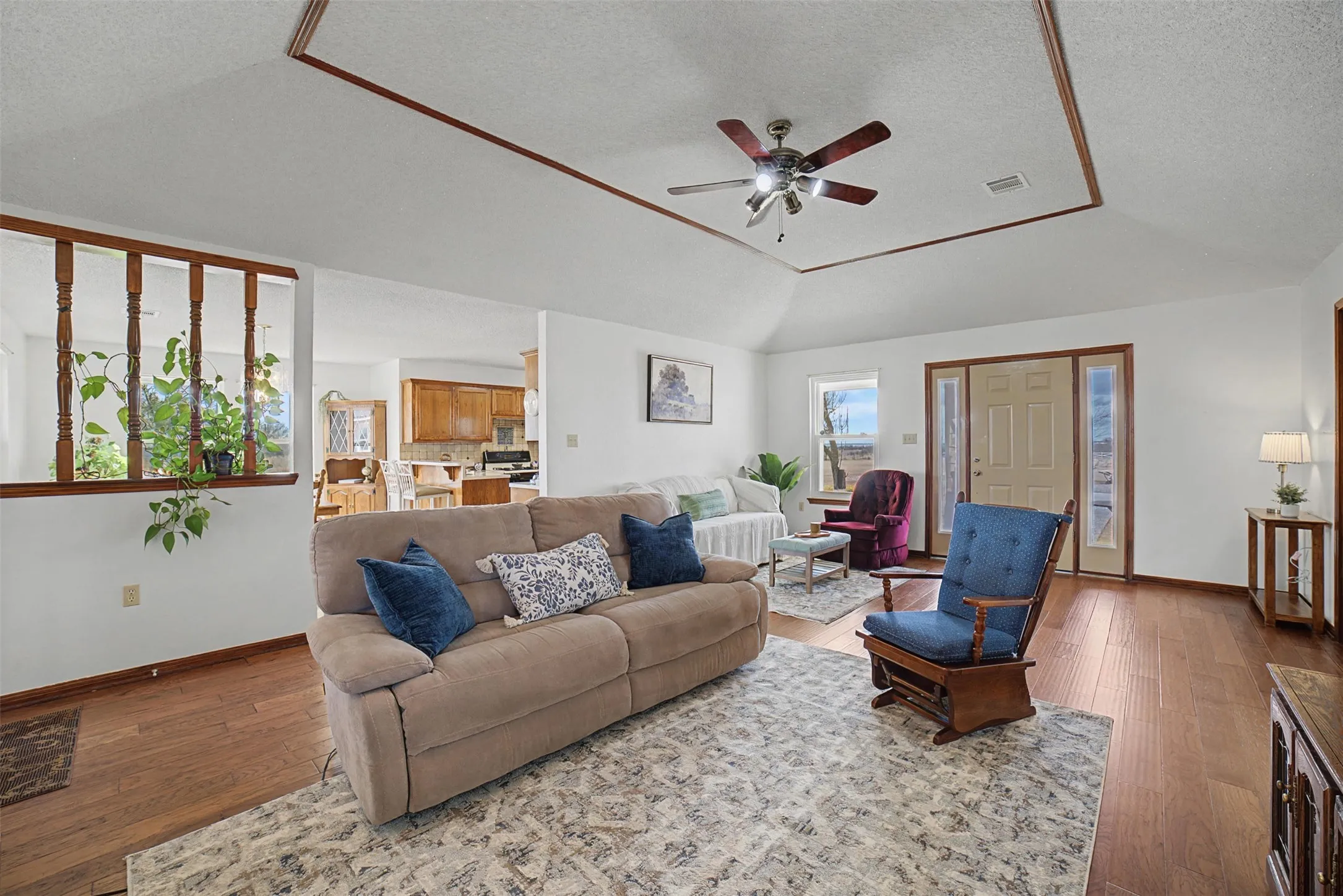 Living room facing front door, dining and kitch