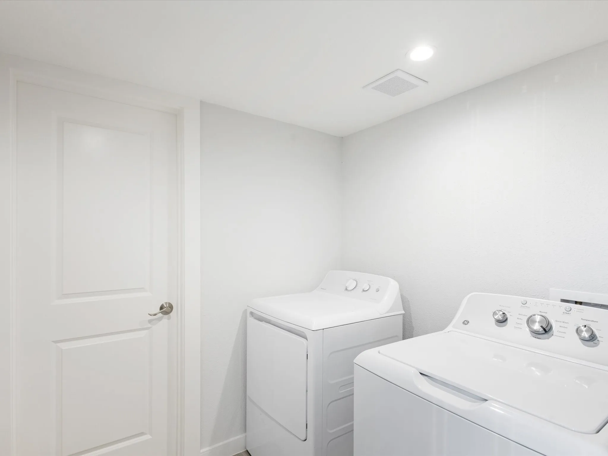 Laundry area with washer and dryer and recessed lighting