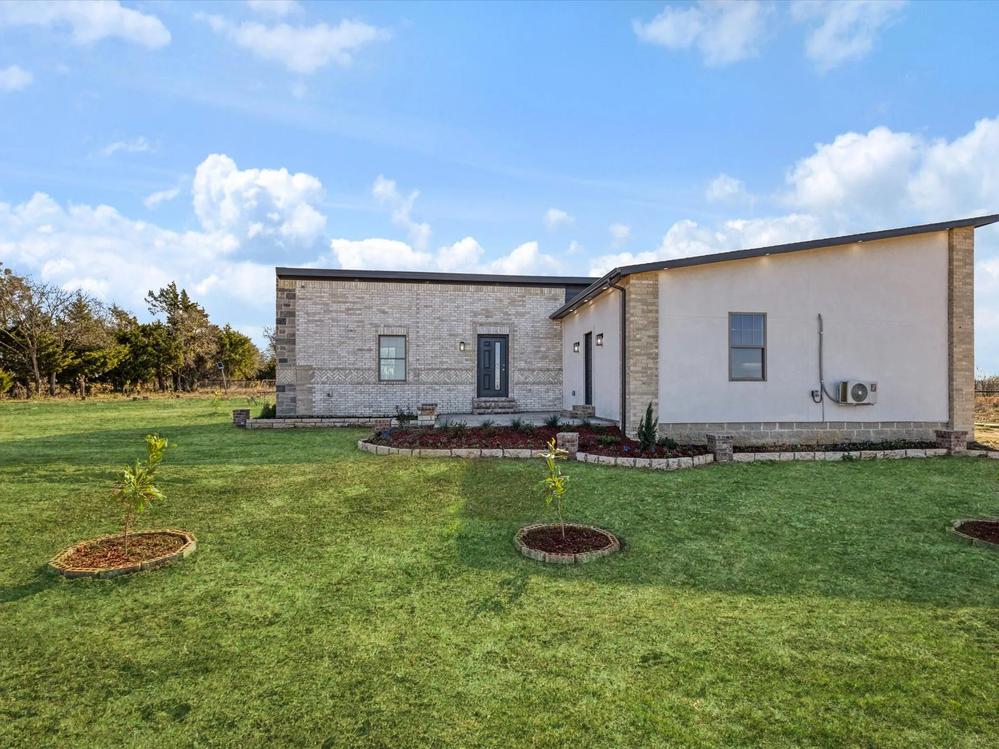 View of front of house with a front lawn and brick siding