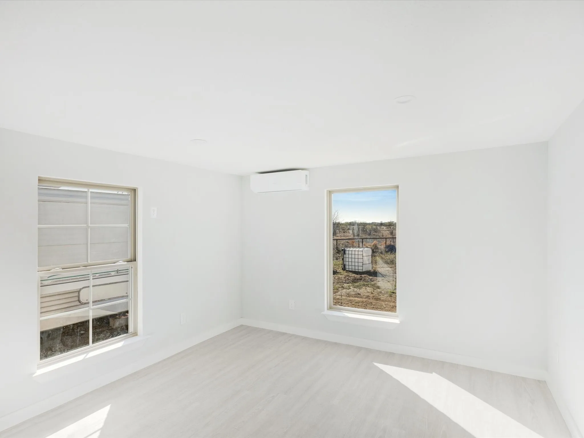 Unfurnished room featuring baseboards and wood finished floors