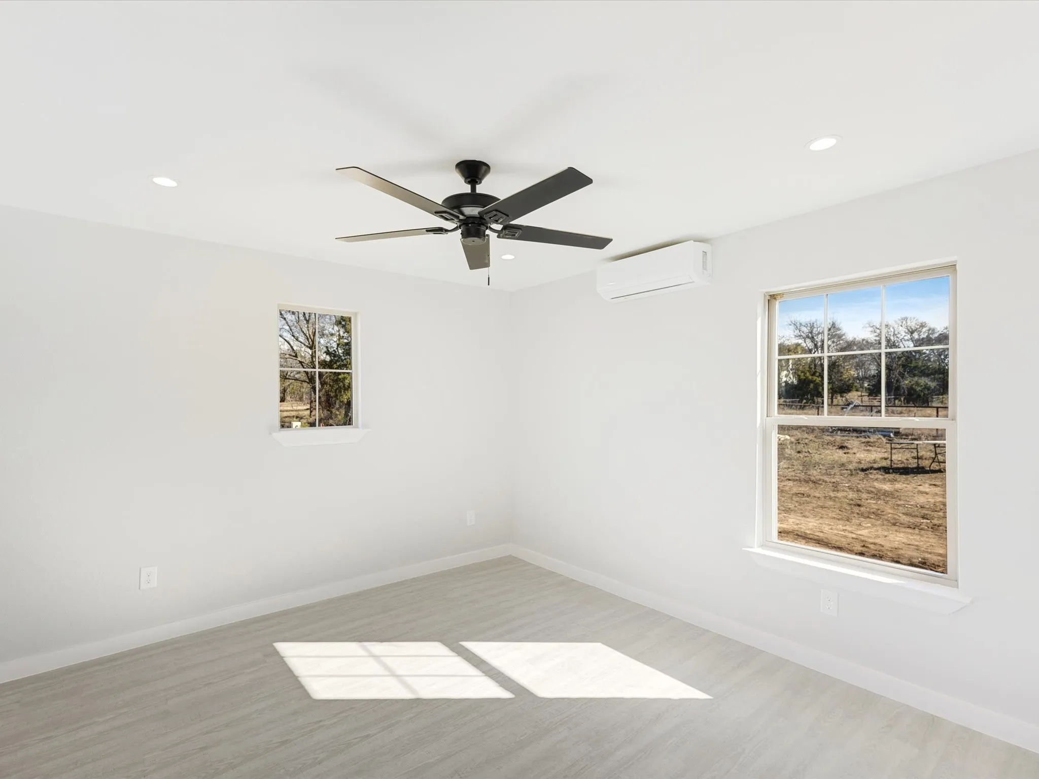 Empty room with a ceiling fan, recessed lighting, and light wood finished floors