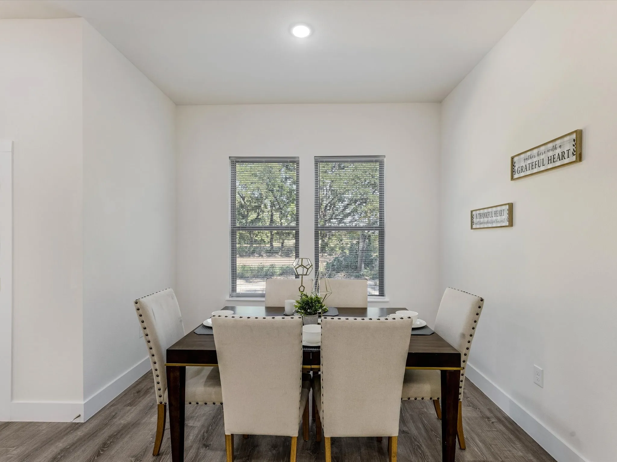 Dining space with baseboards and wood finished floors