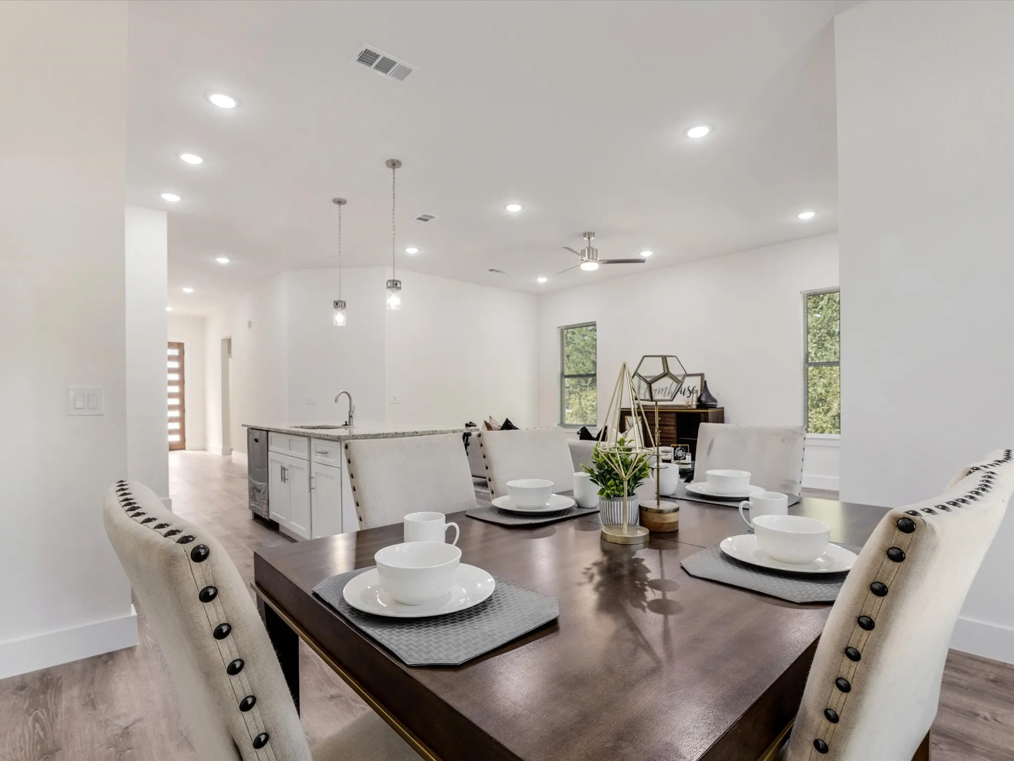 Dining area with light wood finished floors, recessed lighting, ceiling fan, and wine cooler