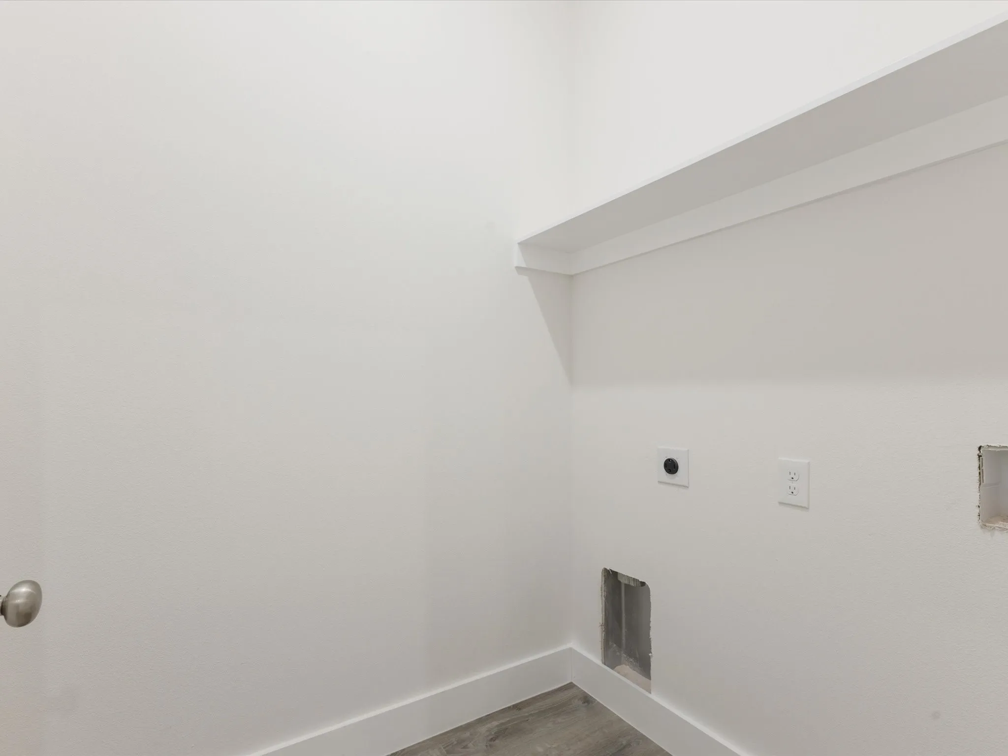 Laundry room featuring wood finished floors and hookup for an electric dryer