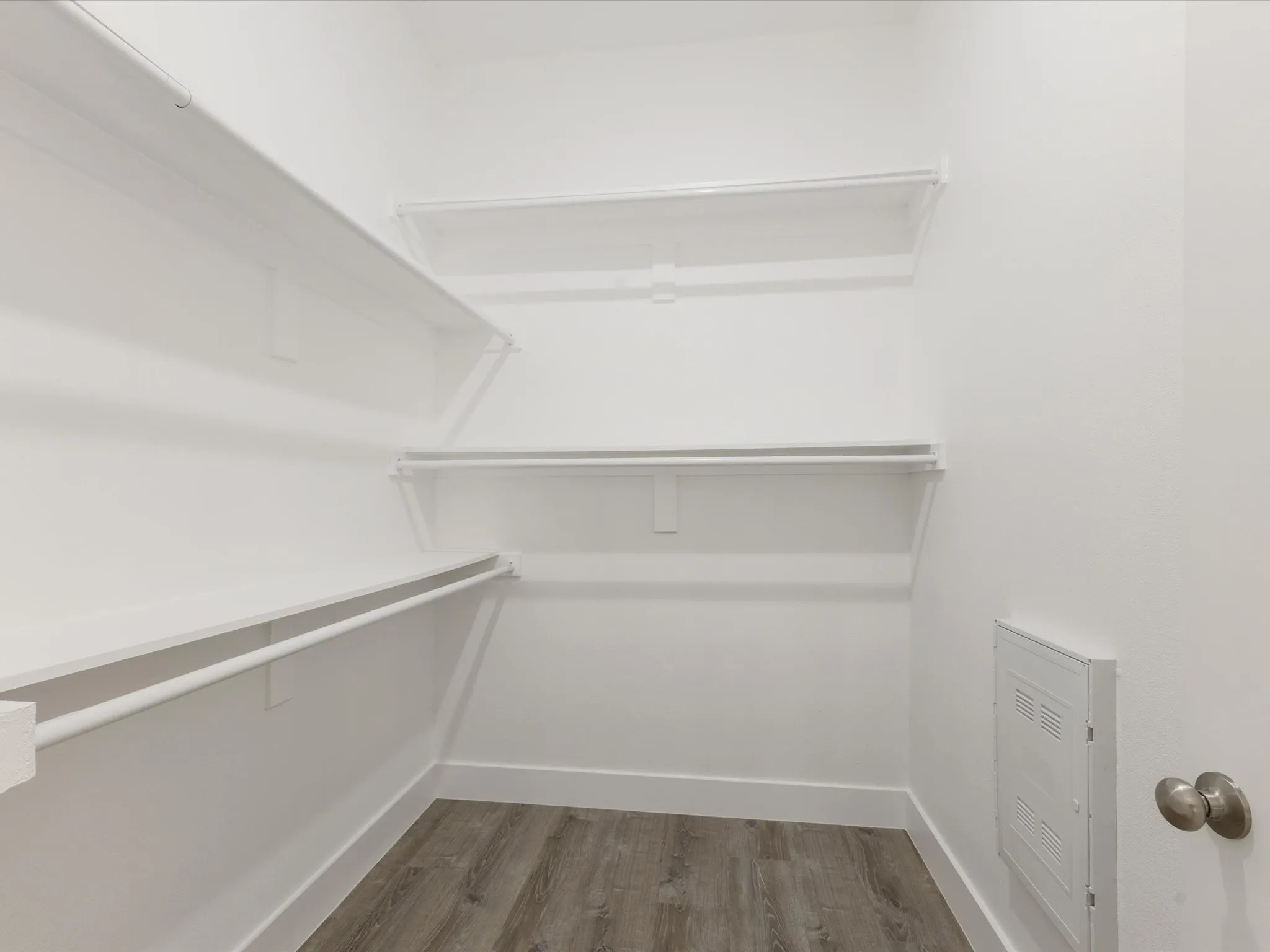 Walk in closet featuring dark wood-style flooring