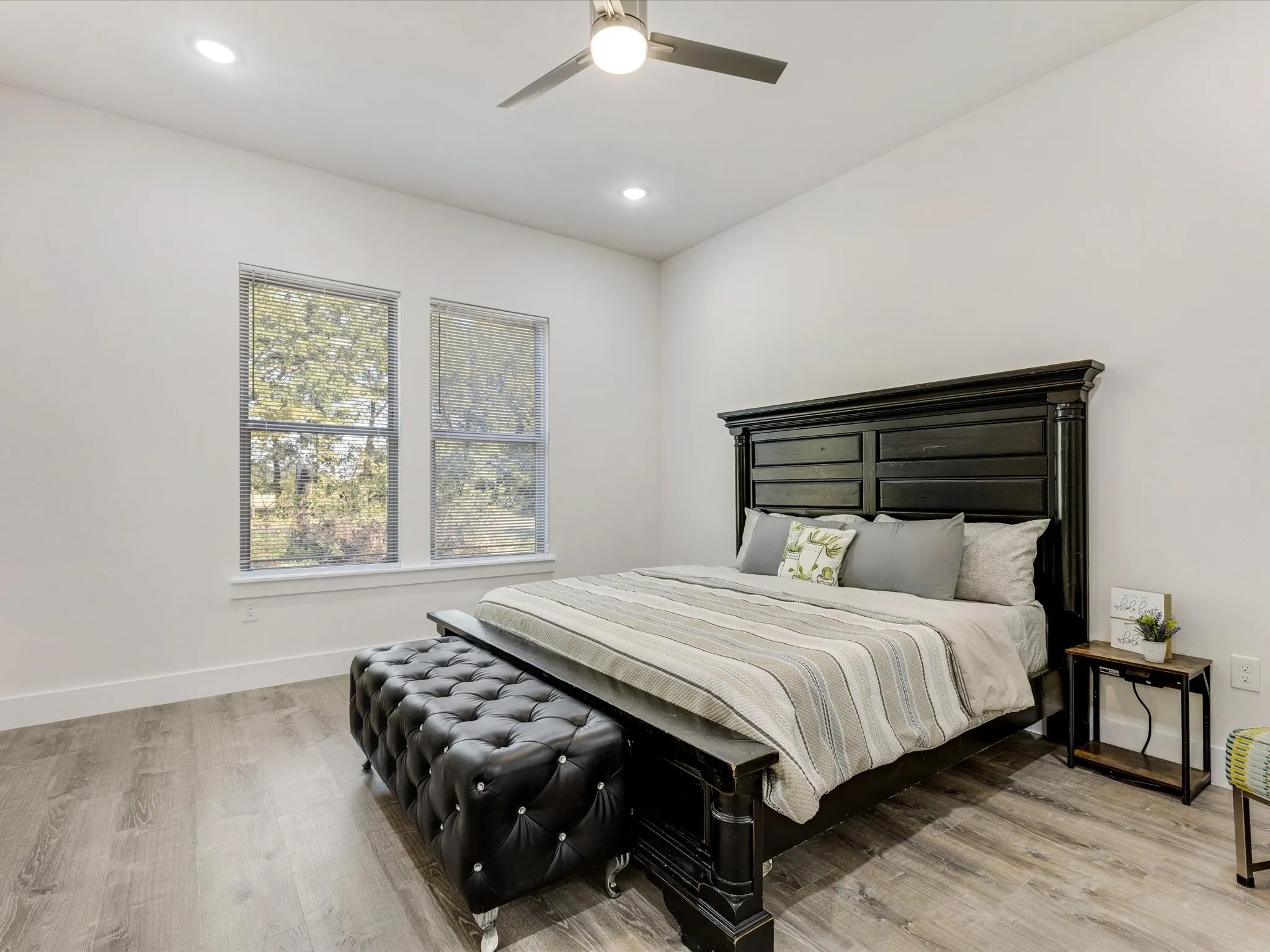 Bedroom with light wood-style floors, a ceiling fan, and recessed lighting