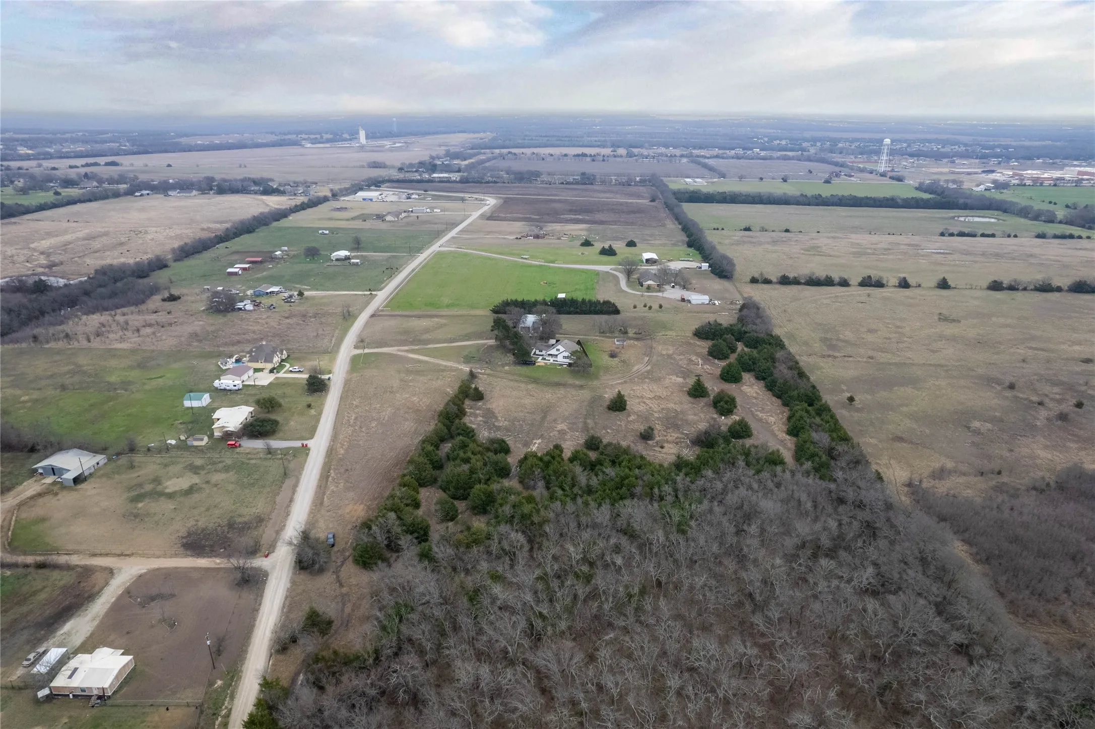 Aerial view of property and surrounding area featuring rural landscape