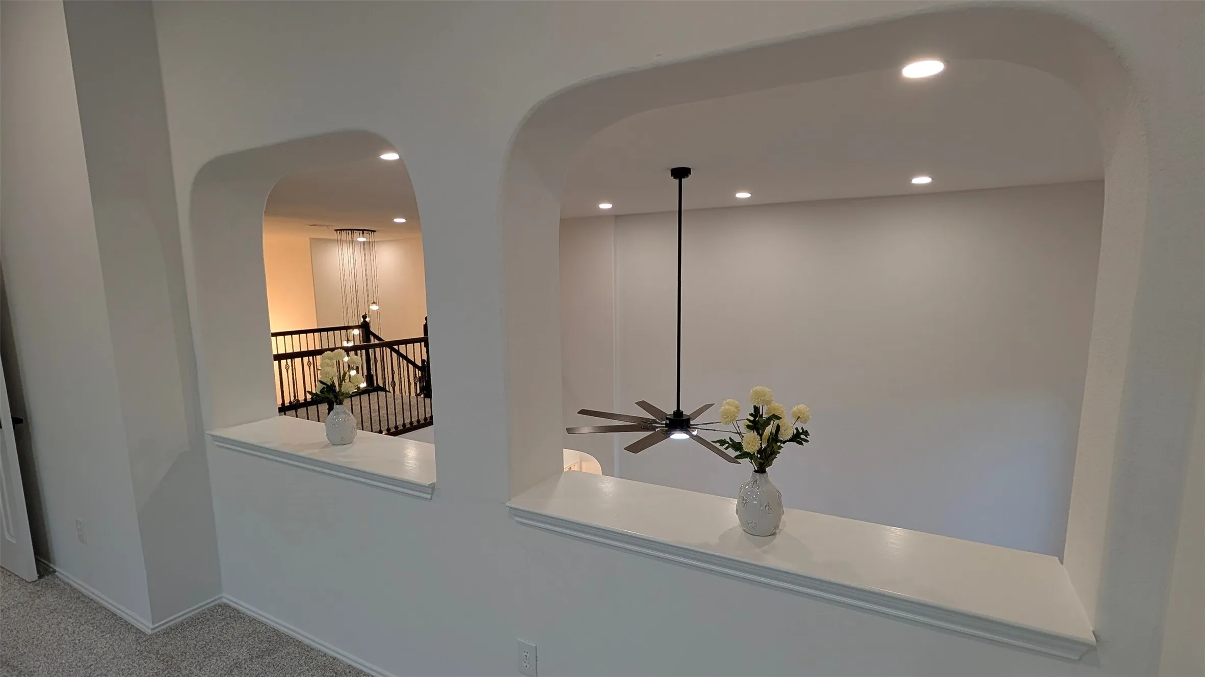 Detailed view of arched walkways, carpet, and recessed lighting
