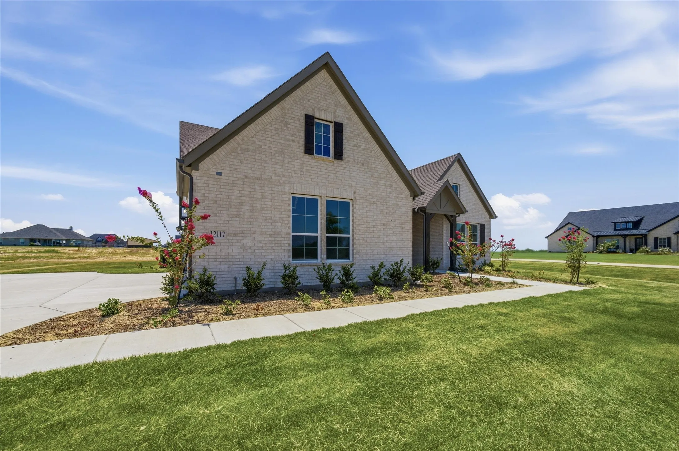 Light brick exterior with dark trim and shutters