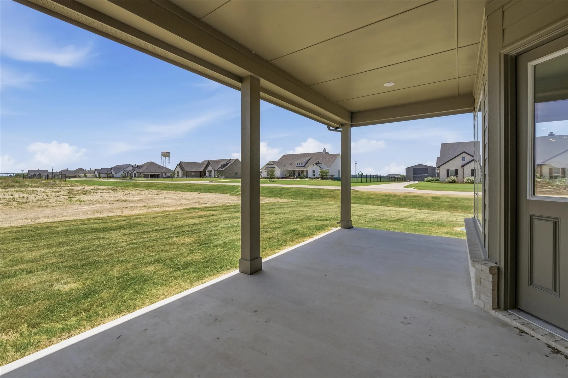 Covered patio featuring a concrete slab and painted support columns