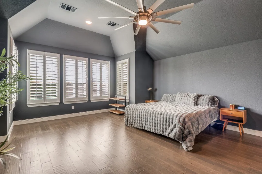 Bedroom with vaulted ceiling, ceiling fan, dark wood-style flooring, and recessed lighting