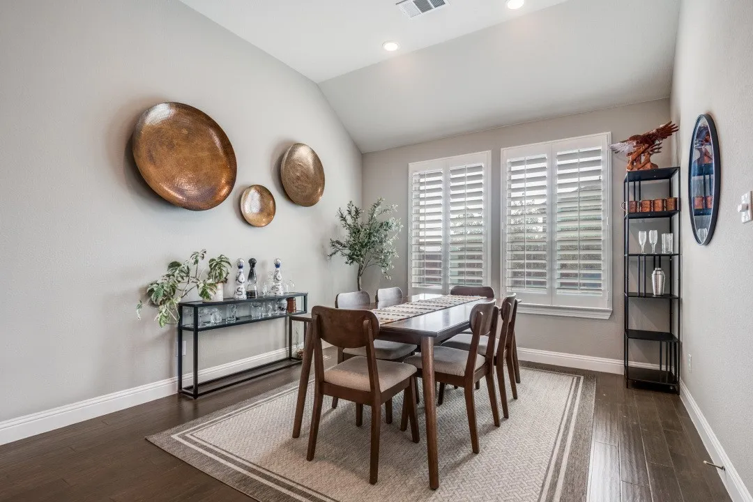 Dining room with vaulted ceiling, dark wood-style floors, and recessed lighting