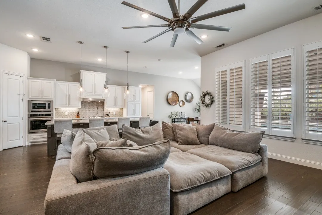 Living area featuring recessed lighting, a ceiling fan, and dark wood-type flooring