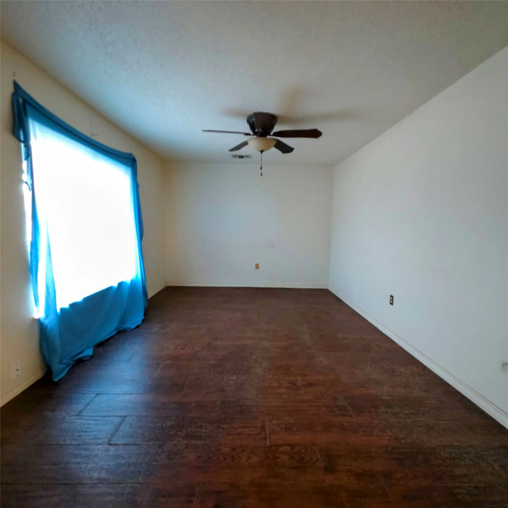 room featuring dark wood finished floors and a ceiling fan