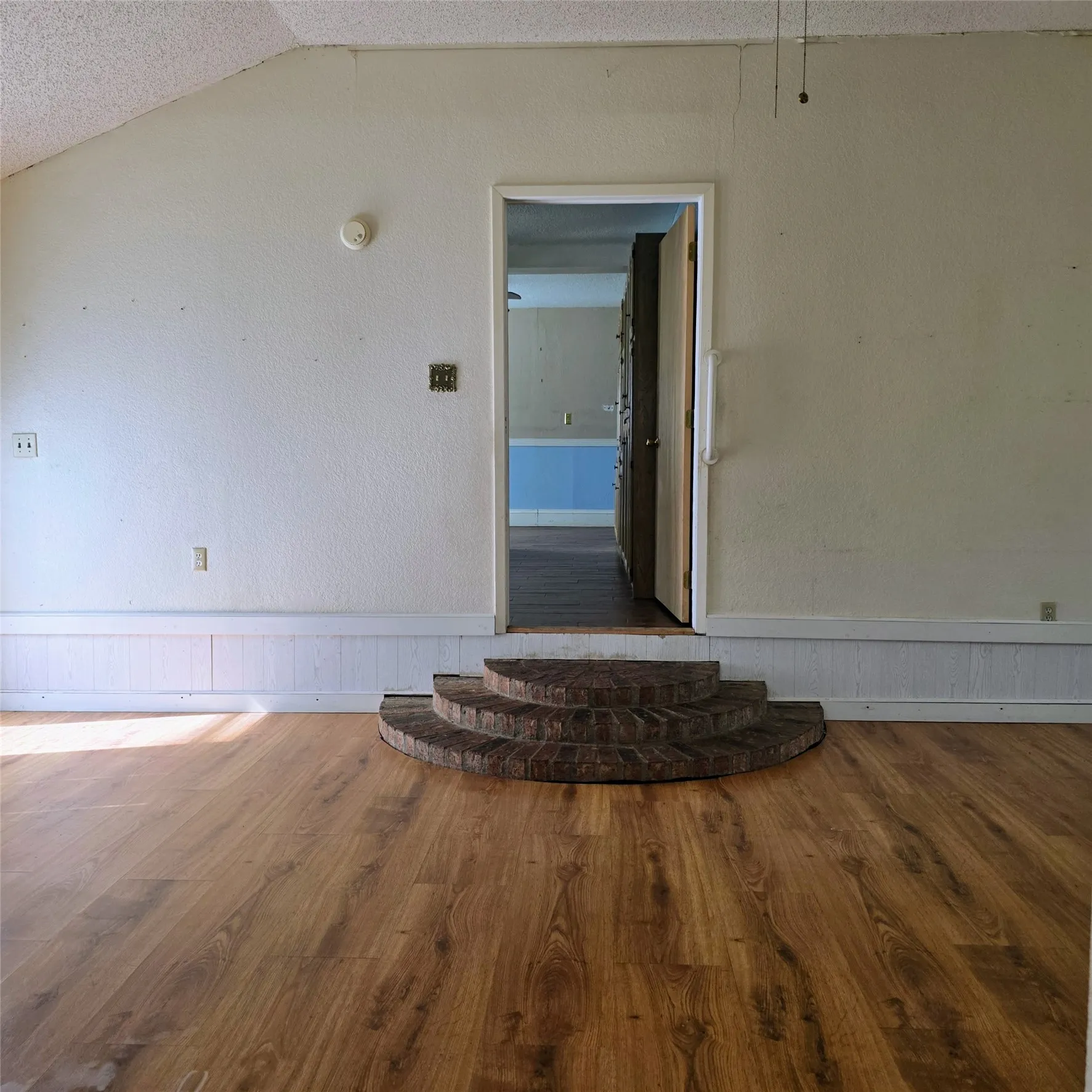 Unfurnished room featuring wood finished floors and baseboards