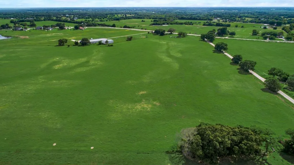 Aerial view of sparsely populated area featuring a pastoral area