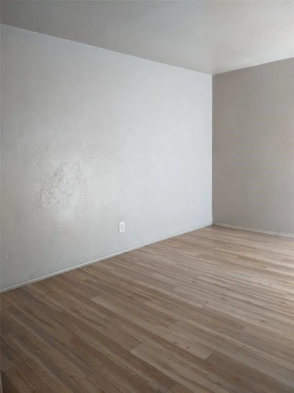 Spare room with wood finished floors