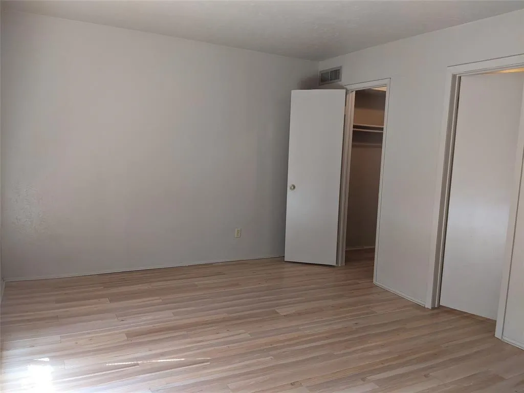 Unfurnished bedroom featuring light wood-type flooring