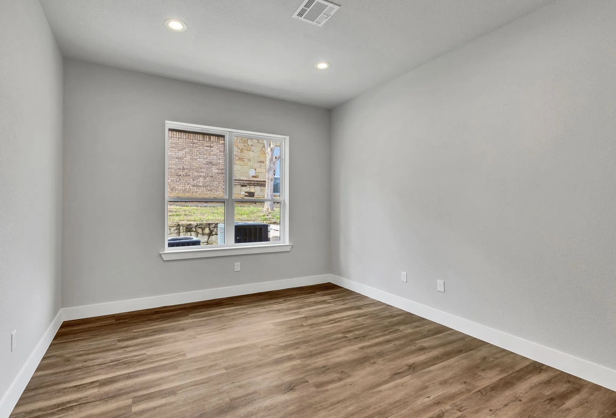 Spare room featuring wood finished floors and recessed lighting