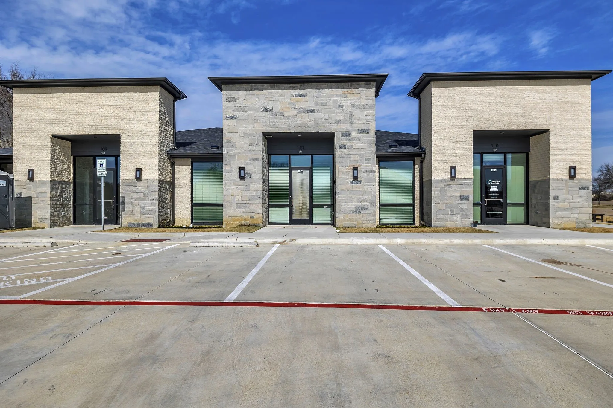 View of building exterior featuring uncovered parking