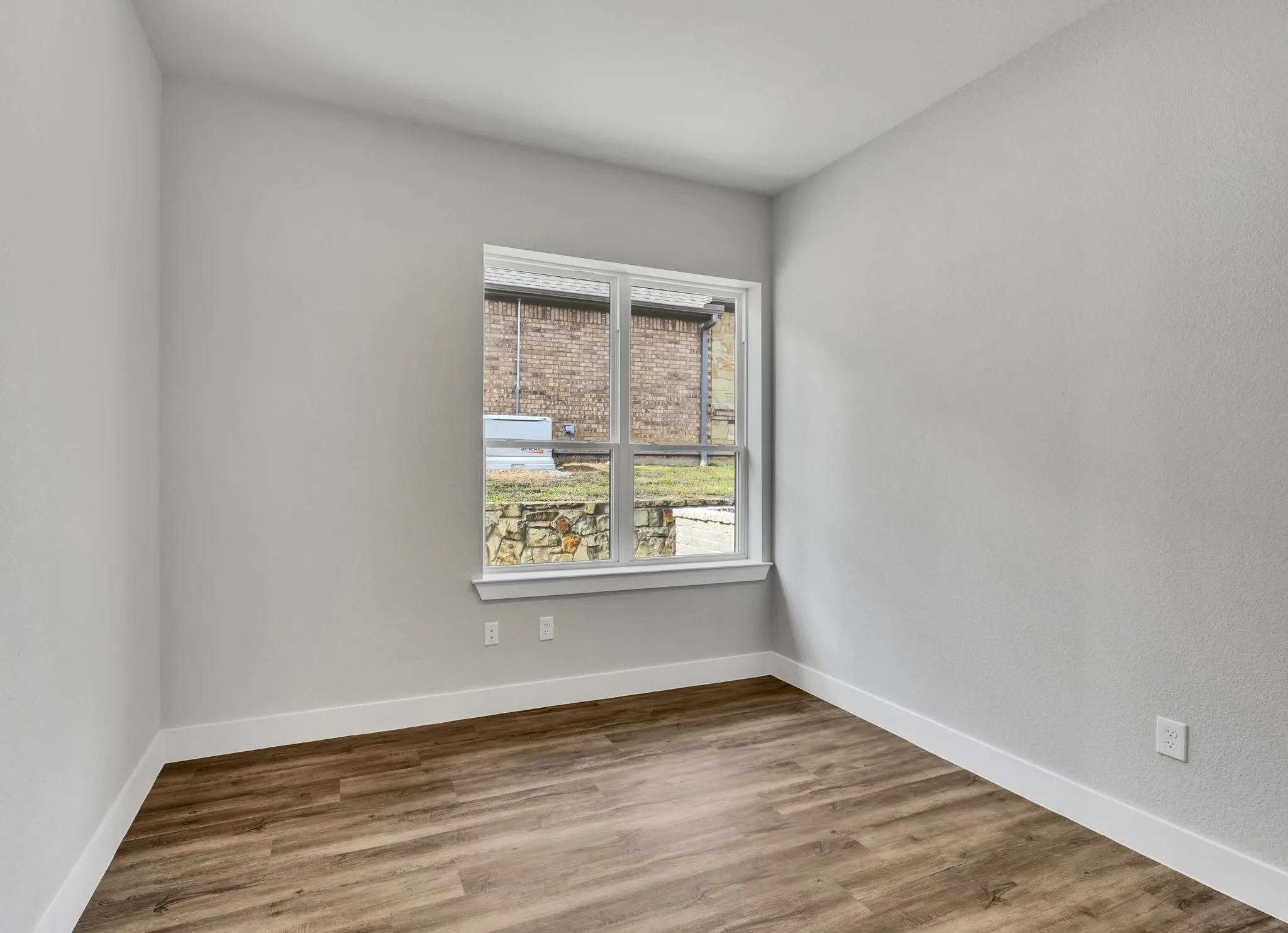 Empty room featuring wood finished floors and baseboards