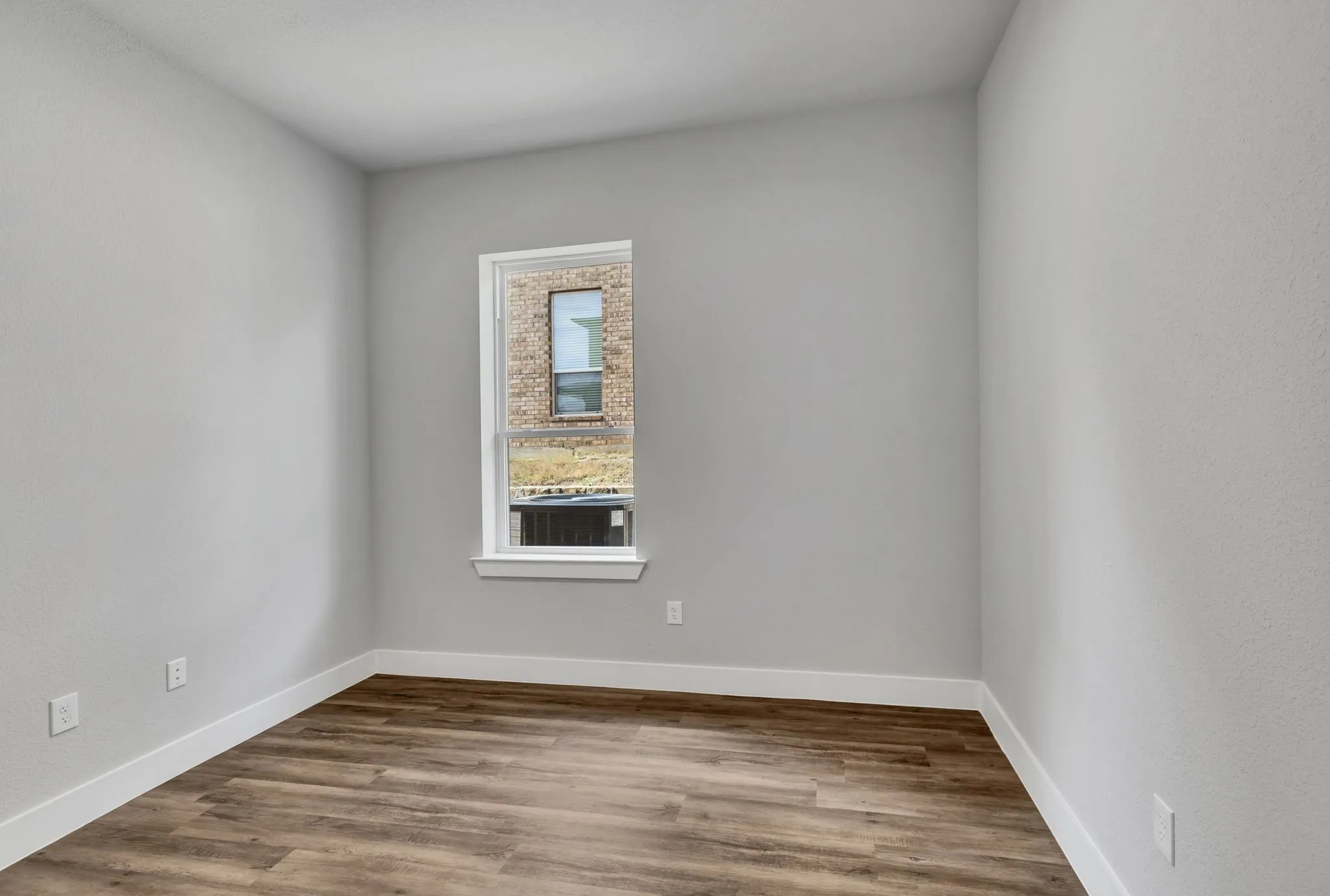 Empty room with wood finished floors and baseboards