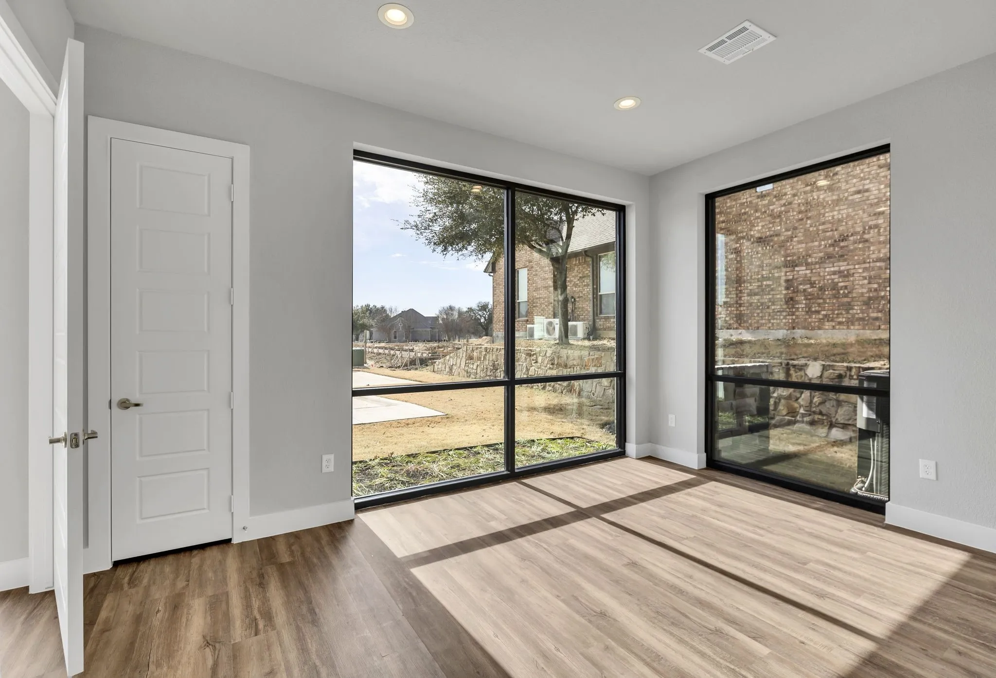 Unfurnished room featuring wood finished floors and recessed lighting