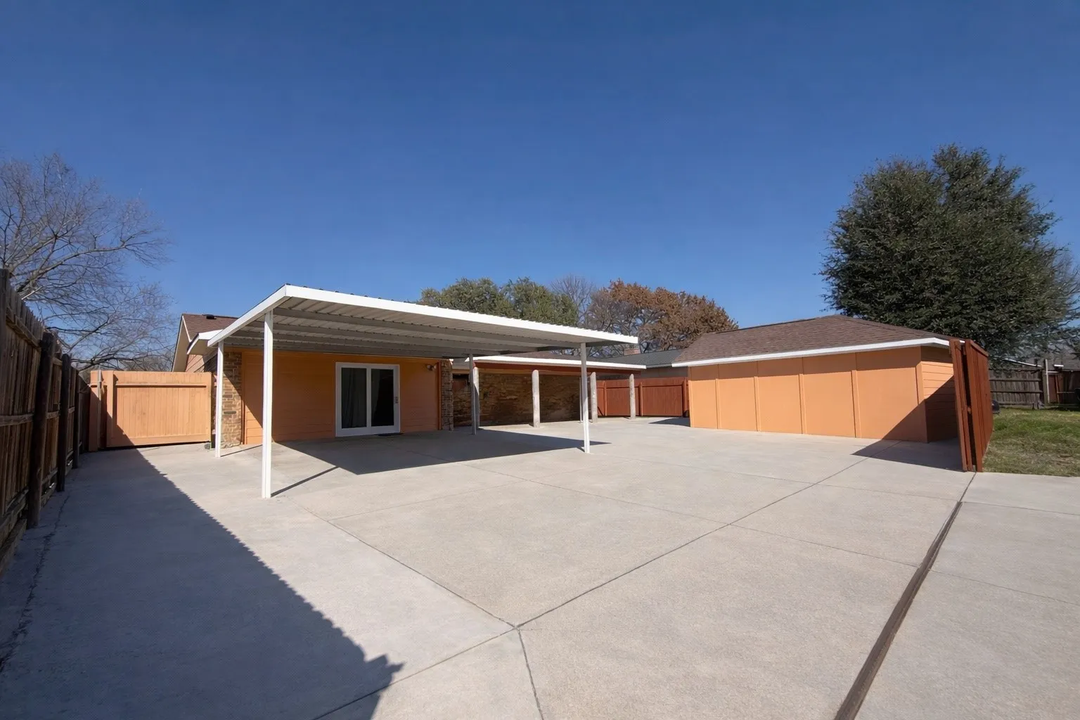 Back of property featuring a fenced backyard and a shed