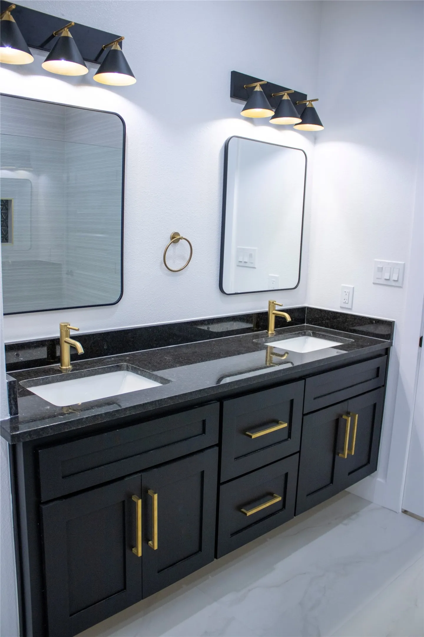 Beautiful double sinks with floating cabinets.