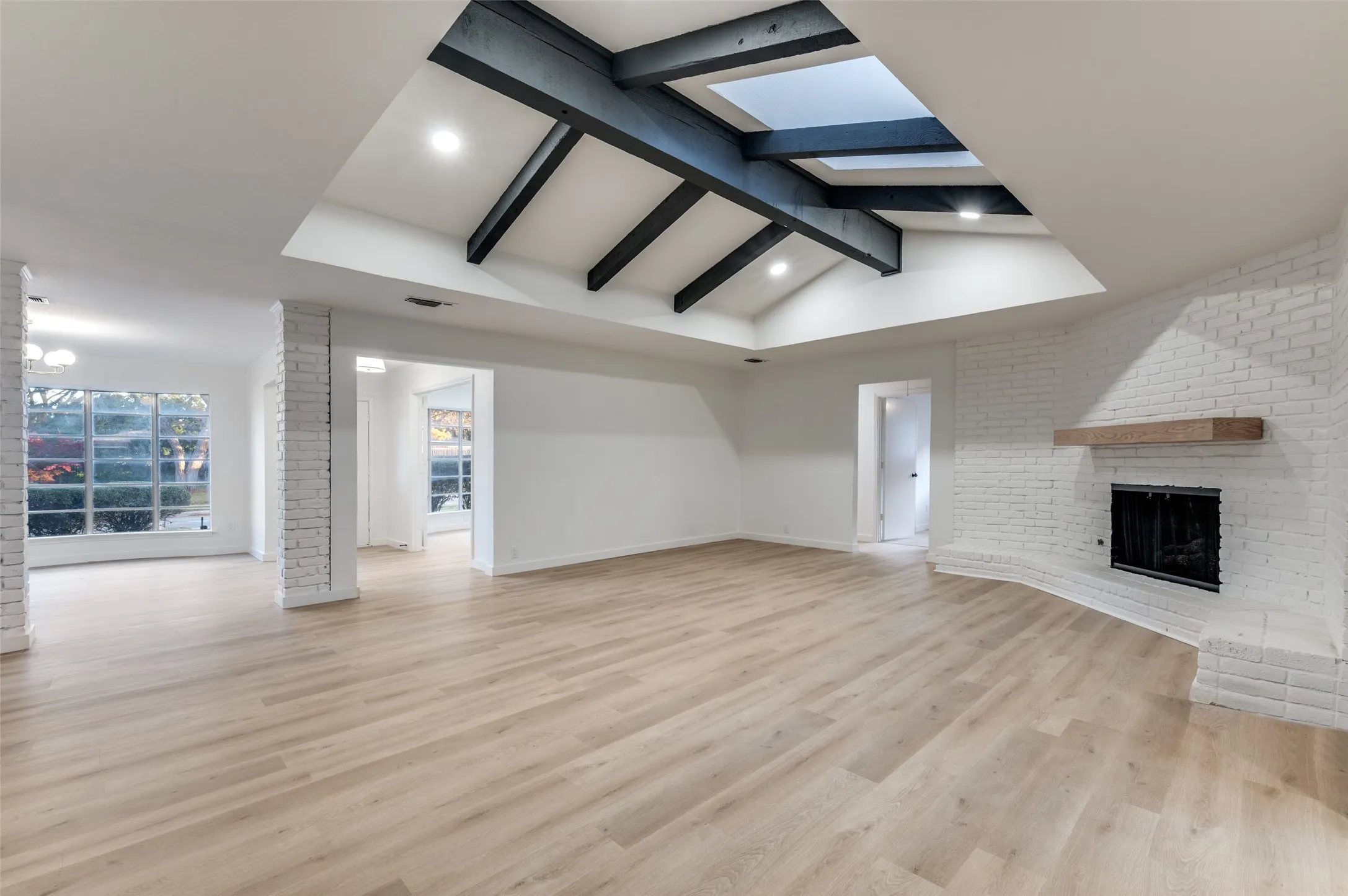 Recessed lighting was added throughout the home as a modern amenity. The expansive living room, with easy access to dining, makes for the perfect gathering space.