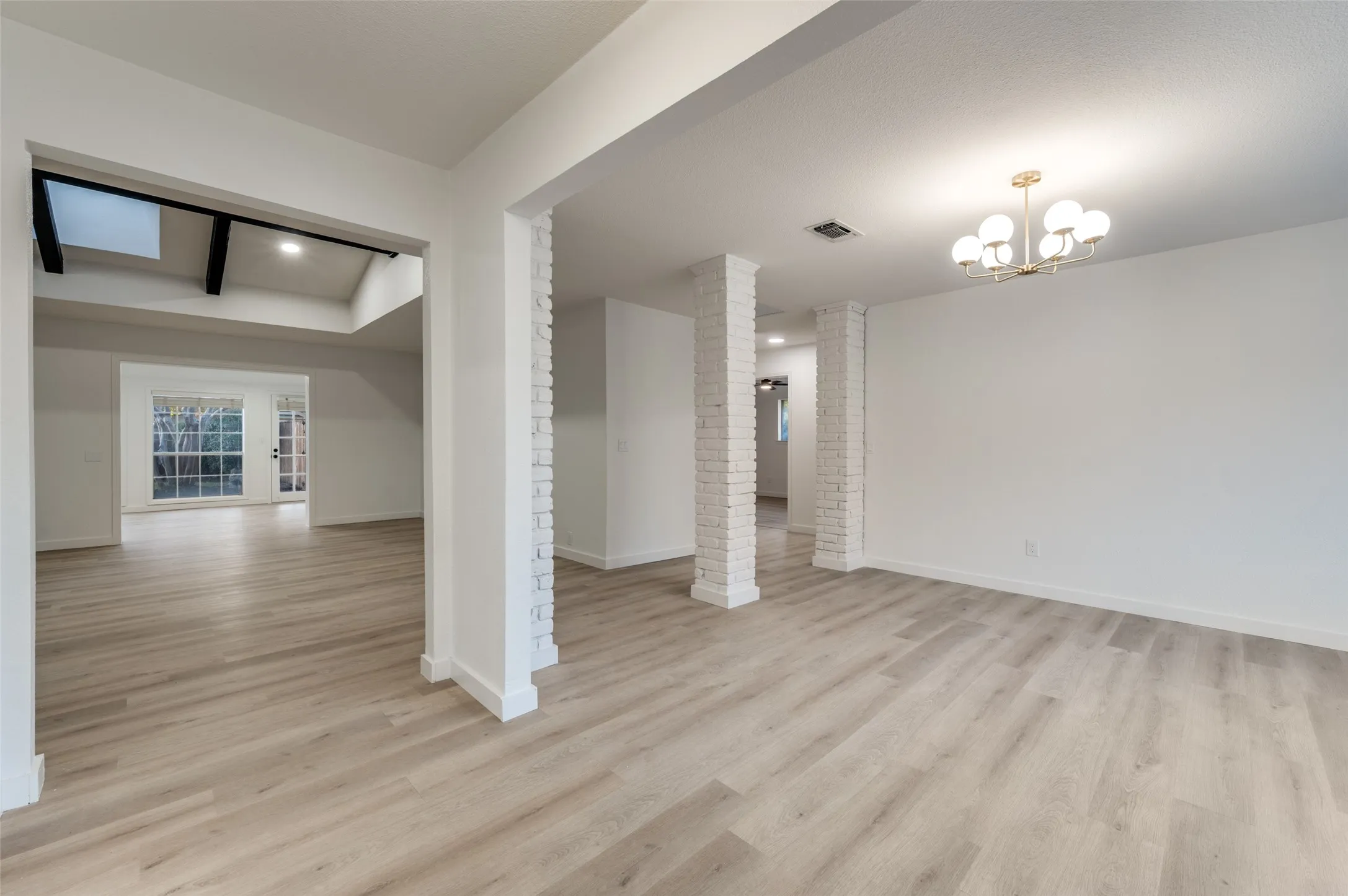 Light-filled interior featuring blonde, water-resistant LVP flooring and a clean, modern palette that reflects natural light beautifully.