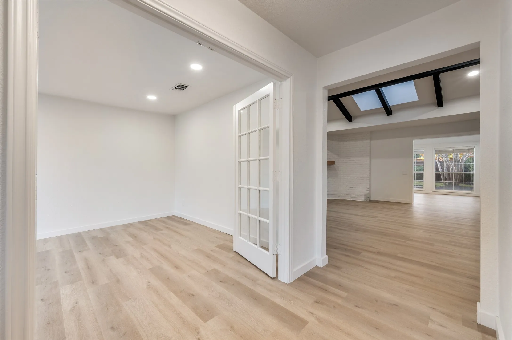 The private office or flex space with French doors and new recessed lighting makes an ideal space for work, study, or additional living needs.