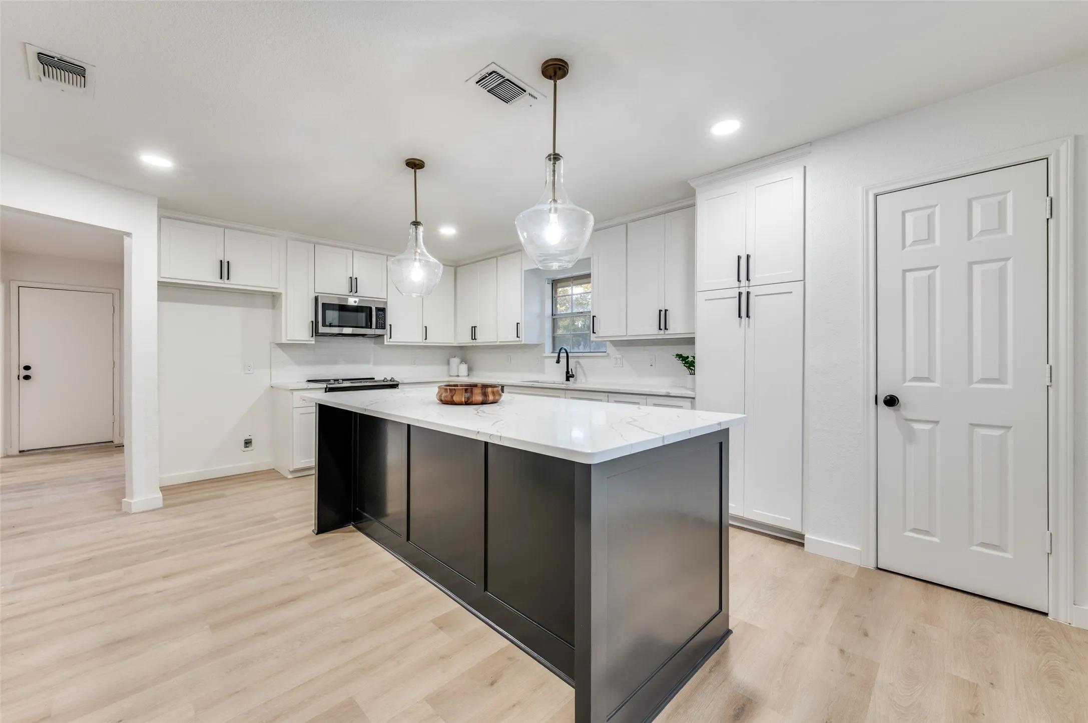 It houses two pantries, one with pull-out drawers and outlets for smaller appliances.