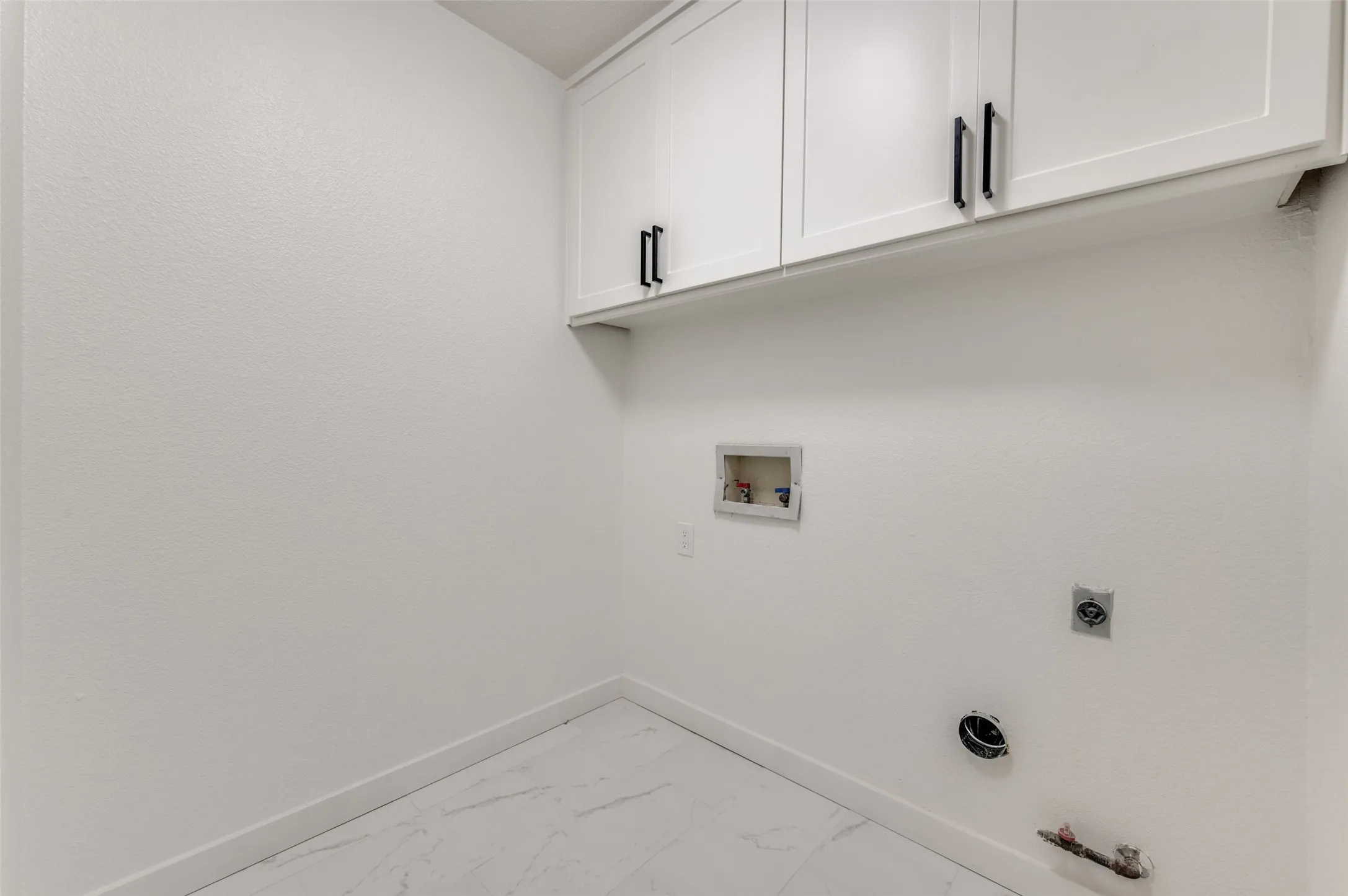 Dedicated laundry room with new cabinetry and closet for storage.