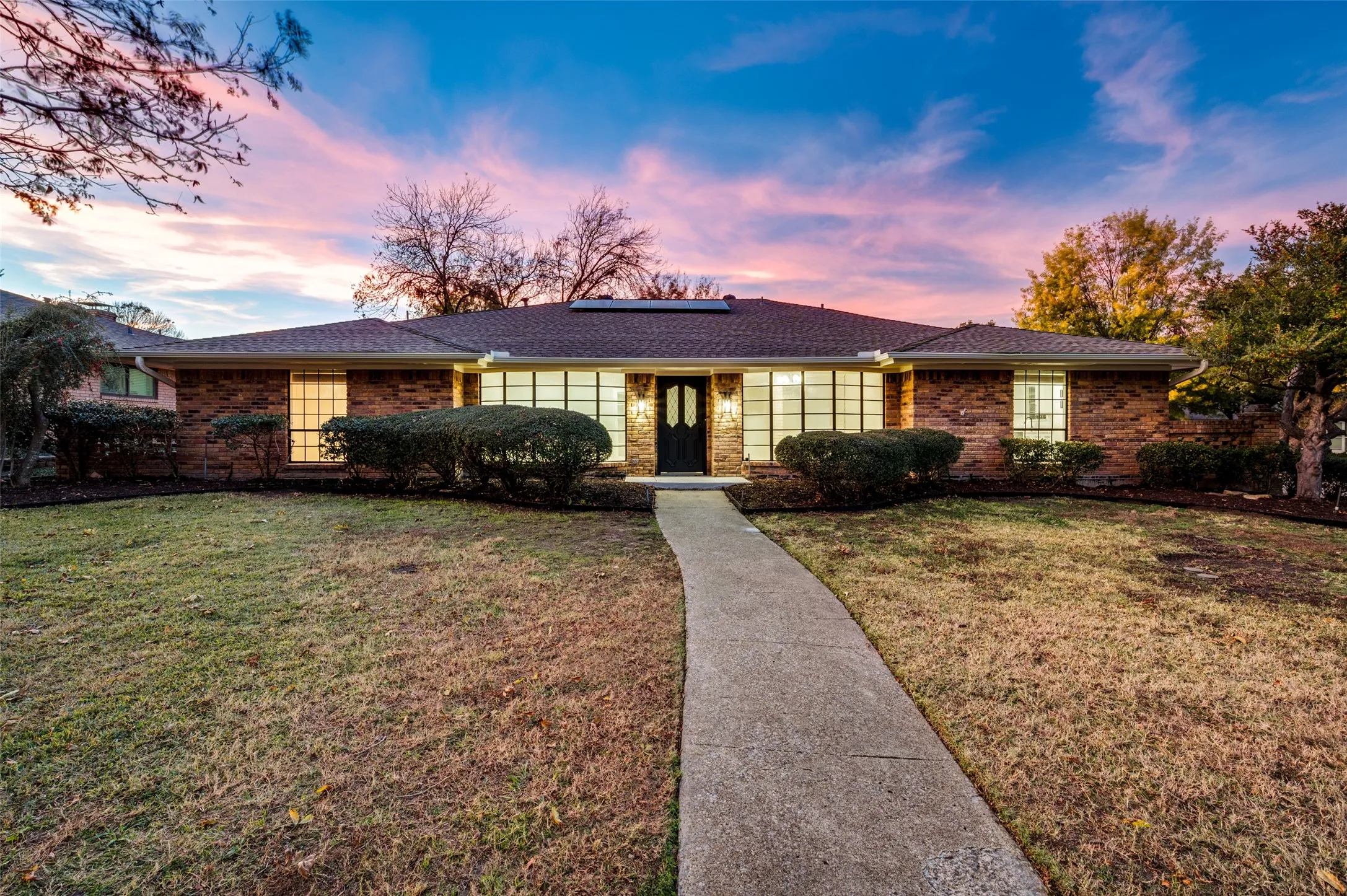 Corner-lot brick home with oversized bay windows and inviting curb appeal. Major structural upgrades include foundation work with transferable lifetime warranty and fully owned solar panels that convey.