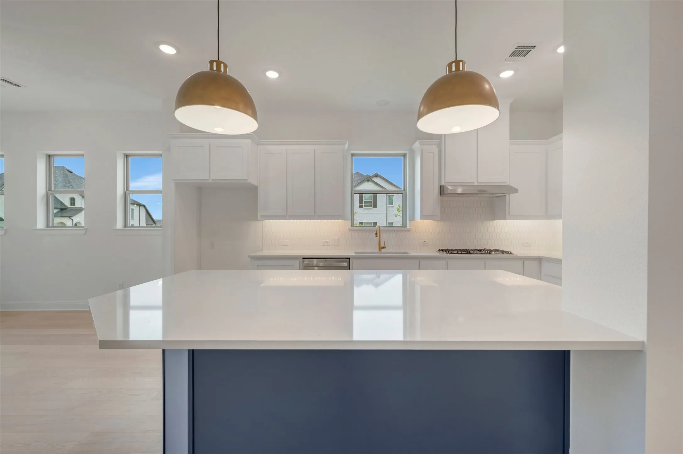Kitchen island featuring a white countertop and a dark blue base