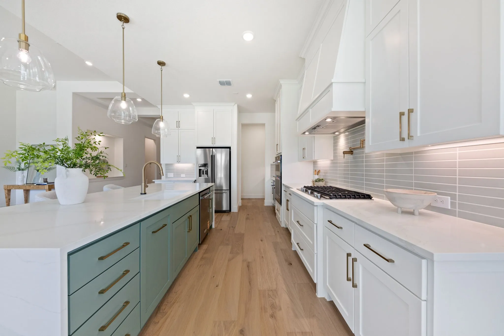 Featuring upgraded design elements like a waterfall island, pot filler, gorgeous flooring and double stacked cabinetry, this dream kitchen is waiting for you to make it your own!
